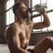 Muscular man drinking water after workout