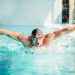 Athletic swimmer swims in butterfly style