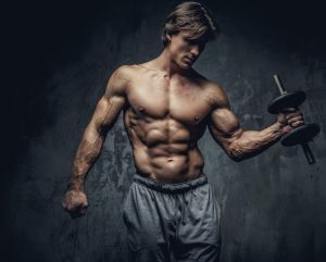 Shirtless bodybuilder holding dumbell.