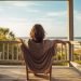 young woman relaxing on the porch of a beach house - HQ stock picture