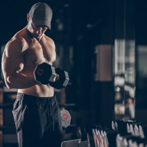 building muscle by lifting dumbbells