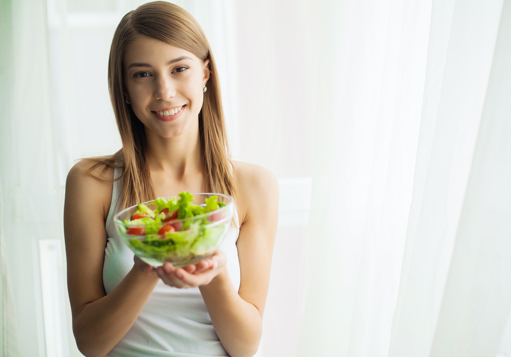 Diet and health.Young woman eating healthy food after workout