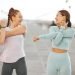 Fitness friends, exercise and wellness with two women stretching and warming up for their workout a