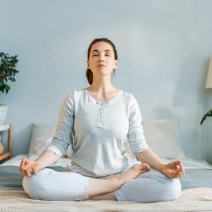 woman enjoying sunny morning and practicing meditation