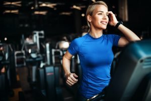 Young attractive woman doing cardio training in gym