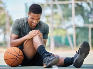 Basketball court, man and injury, knee pain and joint pain, fitness emergency and first aid acciden