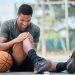 Basketball court, man and injury, knee pain and joint pain, fitness emergency and first aid acciden