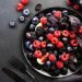 Autumn blue and black berries fruit vegan salad: blueberries, blackberries, grapes, figs