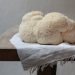 Closeup shot of Lion's mane mushrooms on a white cloth placed on a wooden table