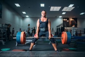 Weightlifter doing exercise with barbell, deadlift