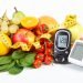 Glucometer for checking sugar level, blood pressure monitor, fruits with vegetables and centimeter