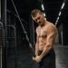 Handsome guy training triceps in gym pumping up body bodybuilding