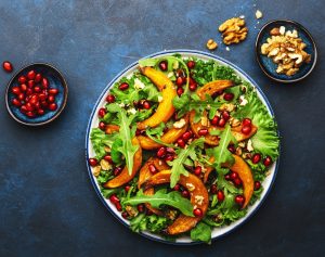 Healthy vegan eating, autumn pumpkin salad with baked honey pumpkin slices