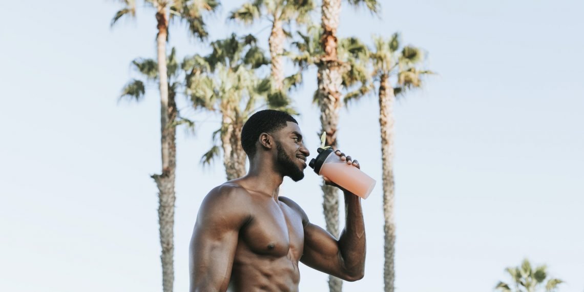 Muscular man drinking a protein shake