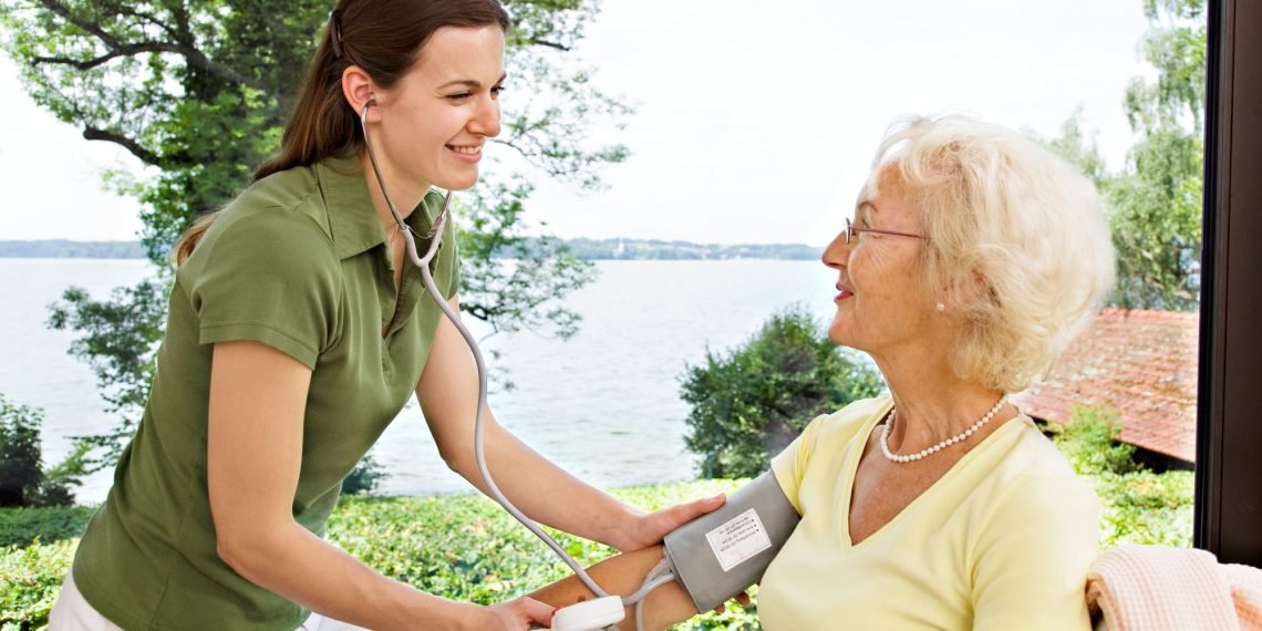 nurse taking woman's blood pressure