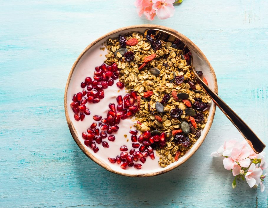 Healthy yogurt bowl with granola and pomegranate