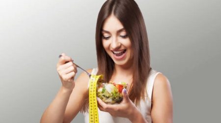 Woman. Diet. Portrait. Womens model with green salad. Adherence to the diet. Fresh Salad.