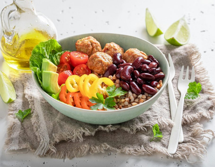 Spicy Mexican salad with groats, meatballs, limes and vegetables.