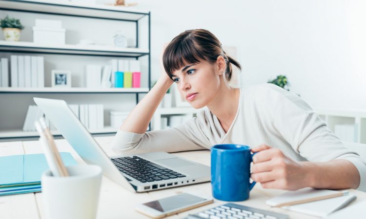 Tired woman at office desk