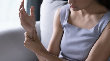 woman suffering pain on hand