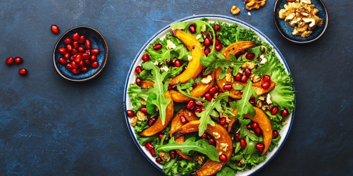 Healthy vegan eating, autumn pumpkin salad with baked honey pumpkin slices
